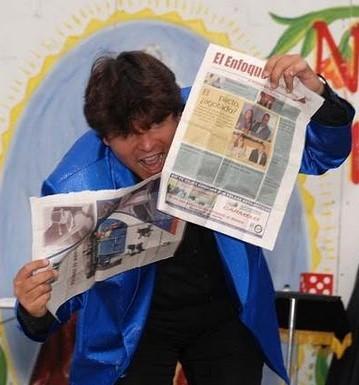Magician Olivier OK Magics doing torn and restored newspaper trick in Tindaya Fuerteventura Spain summer 2010