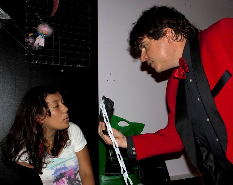 Magician Olivier OK MAGICS interacting with spectator during close-up show in La Porra Pamplona Spain 2011