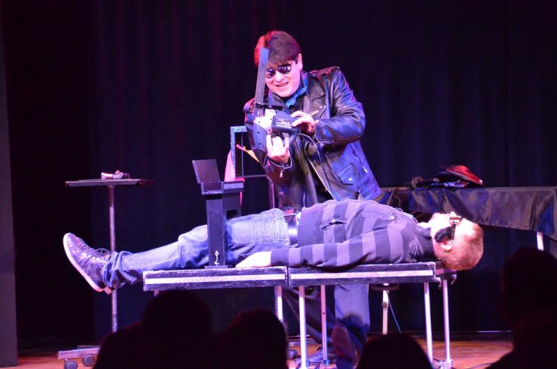 Magician Olivier Klinkenberg OK MAGICS sawing a spectator in half with an electric saw
